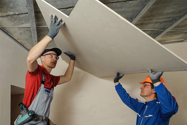 Licensed drywall contractor installing sheetrock in a residential home